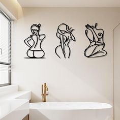 three metal sculptures on the wall above a bathtub