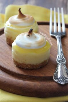 three desserts on a wooden plate with silverware