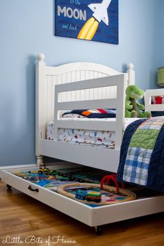 a child's bed with the words repurposed train table in front of it