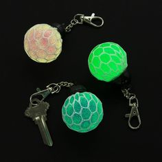 three different colored balls with keys attached to them