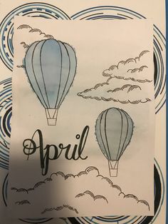 a drawing of two hot air balloons with the word april written on it in black ink