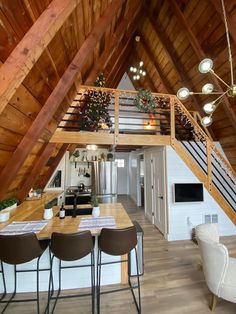 an open loft with wooden walls and ceiling, dining room table and chairs in the foreground