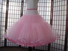 "This listing is for a custom version of the pink tulle petticoat shown in the photos. The waist area is as fitted as possible so that it just fits over the largest part of the body. The waistband is .5\" (1,25cm) wide elastic covered with satin for comfort. The waist area has 2 layers of tulle and is 5\" (12,5cm) long in the photo but can be customized to be shorter or longer, depending on your needs -- just let me know how long the fitted portion needs to be for your dress or else I'll make it Pink Crinoline Petticoat For Party, Fitted Full Skirt Petticoat For Party, Fitted Full Tulle Skirt Petticoat, Fitted Full Tulle Petticoat, Fitted Crinoline Petticoat For Party, Pink Stretch Tulle Petticoat, Fitted Full Skirt Tulle Petticoat, Party Petticoat With Attached Cancan In Pink, Fitted Tulle Petticoat Full Skirt