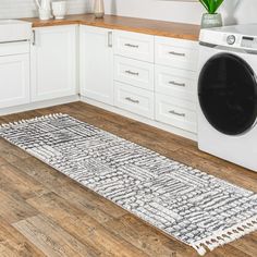 a white washer sitting next to a dryer in a kitchen