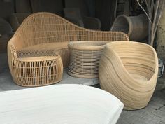 wicker furniture is displayed on the sidewalk