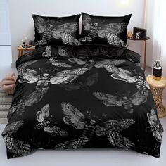 a bed with black and white butterflies on it