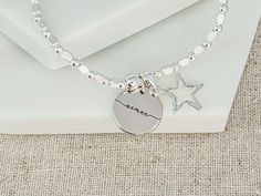 Personalised Star Stacking Bracelet with Engraved Name Charm Introducing our cute Star Bracelet, an elegant addition to our new range of stacking bracelets. Perfectly designed for those who adore a touch of charm, it stands out beautifully when worn solo, or you can pair it with other bracelets from our collection for a layered look. ☆ Product Details: * Material: Silver plated. * Bracelet Type: Beaded stretchy bracelet. * Charm: Silver plated star charm, with an engraved name disc charm. * Size: This stretchy bracelet comfortably fits most wrist sizes. * Gift Box: Considering gifting? Opt to add a gift box for that special touch. ☆ How to Order: * Choose whether to add a gift box from the dropdown box. * Personalise Your Bracelet: Write the initial you would like in the personalisation bo Silver Beaded Bracelets With Star Charm As Gift, Silver Beaded Bracelet With Star Charm For Gift, Silver Beaded Bracelet With Star Charm As Gift, Silver Star Bracelet For Friendship, Silver Friendship Bracelets With Star Charm, Silver Bracelet With Star Charm For Friendship, Silver Bracelets With Star Charm For Friendship, Jewelry Star, Stacking Bracelets