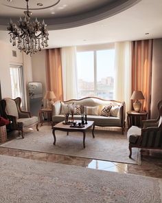 a living room filled with furniture and a chandelier