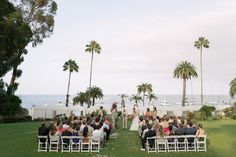 an outdoor wedding ceremony with palm trees