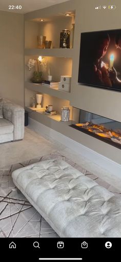 a living room filled with furniture and a flat screen tv mounted on the wall over a fireplace