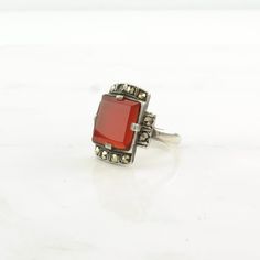 This ring is a size 7 3/4 (USA); It may be resized. Markings: 925 (Tested & guaranteed to be Sterling Silver) This ring weighs 4.9 Grams The Stone/Design is Red Carnelian Marcasite - Natural  The Stone/Design measures 11.4 x 11.4 mm The Ring face measures 19.5 x 13.1 mm The condition of this ring is Estate, Great, heavy patina  This vintage item is circa 1920  To have us do the resize, add this listing and the resize listing to your cart and select which size you would like this ring to be on th Art Deco Red Rectangular Jewelry, Red Rectangular Art Deco Jewelry, Vintage Silver Carnelian Rings, Vintage Carnelian Hallmarked Ring, Classic Carnelian Jewelry For Anniversary, Red Carnelian Hallmarked Rings, Antique Red Rectangular Rings, Antique Carnelian Rings For Anniversary, Red Carnelian Vintage Jewelry