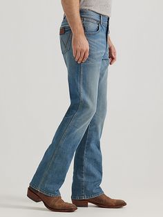 NOTHING BEATS AN ORIGINAL, BUT THIS MIGHT Since 1947, Wrangler® jeans have been a cowboy-approved wardrobe staple. Inspired by our Western heritage, these Wrangler® Retro® jeans combine our most iconic features with contemporary fits and washes. This updated classic features the same worn leather patch with our rope logo, 'W' stitching on the back pockets, and five-pocket styling. These men's slim bootcut jeans feature a streamlined silhouette through the seat, thigh, and knee, but the leg widen Jeans And Cowboy Boots Outfit Men, Western Style Jeans With Standard Cut Leg, Western Jeans With Five Pockets And Standard Cut Leg, Western Style Straight Leg Jeans For Rodeo, Casual Straight Leg Jeans For Western-themed Events, Rugged Dark Wash Bottoms For Ranch, Western Straight Leg Jeans For Rodeo, Rugged Straight Leg Bottoms For Ranch, Western Style Jeans With Five Pockets