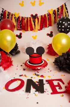 a mickey mouse birthday party with balloons and decorations