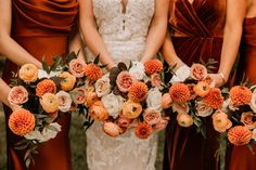 the bridesmaids are holding their bouquets with orange and white flowers in them