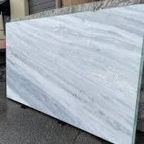 a large white marble slab sitting on top of a sidewalk