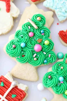 christmas tree cookies decorated with green icing and candies