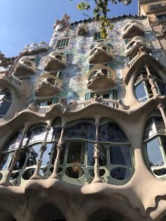 the facade of a building with many windows and balconies on it's sides