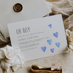 a close up of a note and a pen on a table with flowers in the background