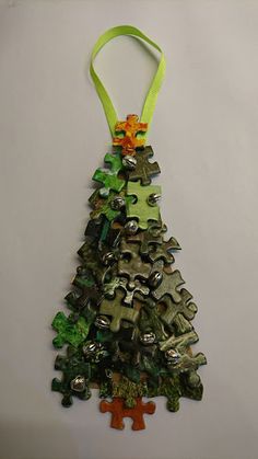 an ornament shaped like a christmas tree with green and orange ornaments on it