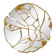 a gold leaf shaped mirror on a white background