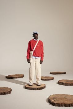 a man standing on top of wooden slices