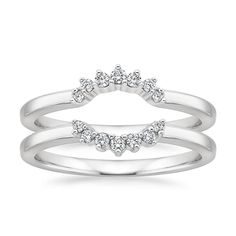 a white gold ring with three diamonds on it