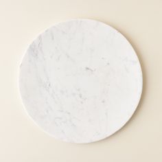 a white marble plate sitting on top of a table