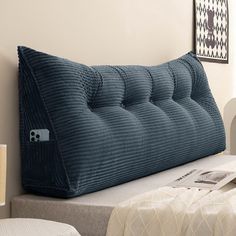 a blue pillow sitting on top of a bed