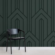 a chair sitting in front of a green wall with geometric designs on the back and sides