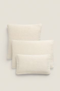 two white pillows sitting next to each other