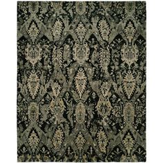 an area rug with many different designs and colors on it, including black, green, beige