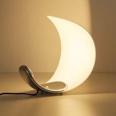 a lamp that is shaped like the moon and has a cord plugged into it