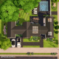 an aerial view of a house with a car parked in the driveway and trees surrounding it