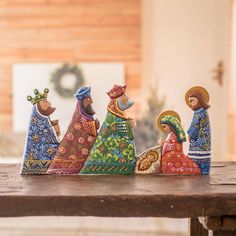 a group of figurines sitting on top of a wooden table