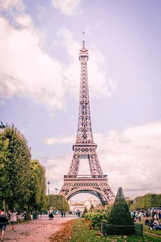 the eiffel tower is very tall and has many people walking around in it