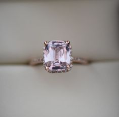 an engagement ring with a pink diamond in the center