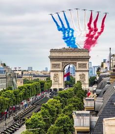 red, white and blue jets fly over the arc de trioe