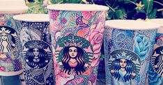 several starbucks cups with different designs on them