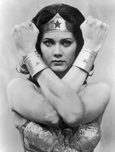 the wonder woman is posing with her hands on her head