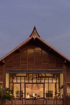 a large wooden building sitting on top of a lush green field