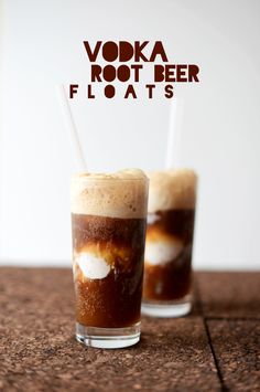 two glasses filled with liquid and ice on top of a wooden table next to the words vodka root beer floatts