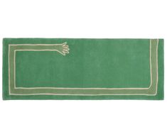 a green rug with an arrow on the front and white trimmings around it