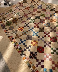 a large quilt is laying on the floor