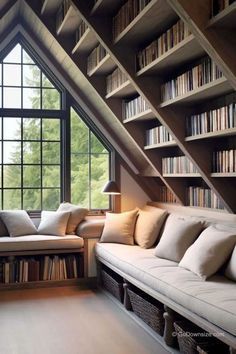 a living room filled with lots of furniture under a slanted ceiling covered in bookshelves