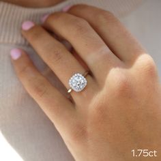 a woman's hand with a diamond ring on top of her finger and the bottom half of her left hand