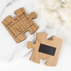 two pieces of wooden puzzle with the date and time printed on them, sitting next to each other