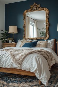 a bed sitting under a large mirror in a bedroom