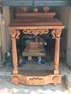 an old wooden table with carvings on it in a room that is being worked on