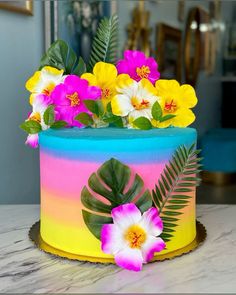 there is a colorful cake with flowers on it