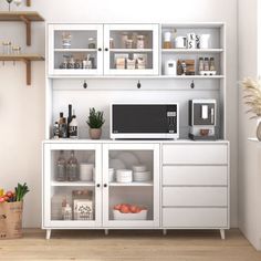 a kitchen with white cupboards and shelves filled with food, drinks and other items